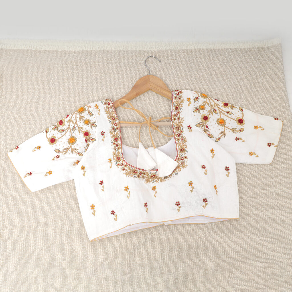 White silk Aari work hand embroidery blouse detailed closeup