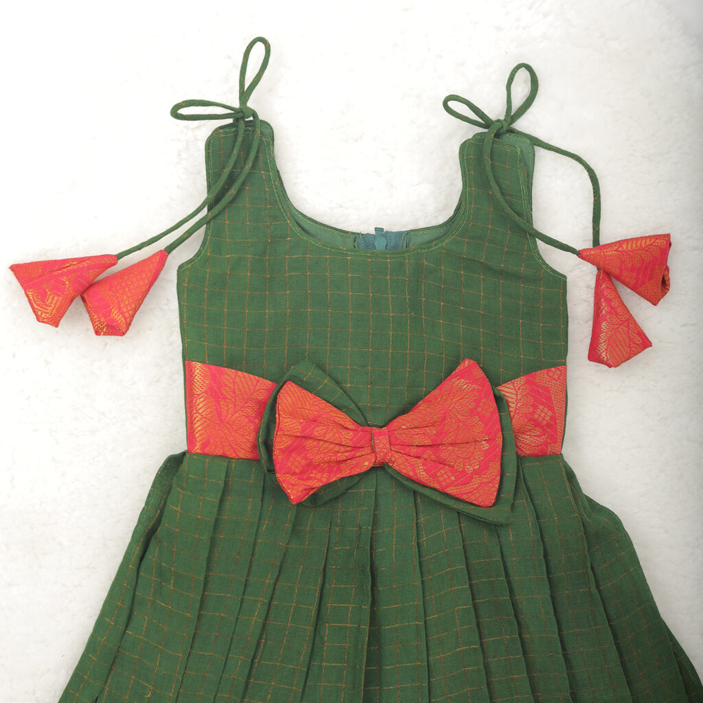 Close up pattern detail of Amora green red kids festive frock