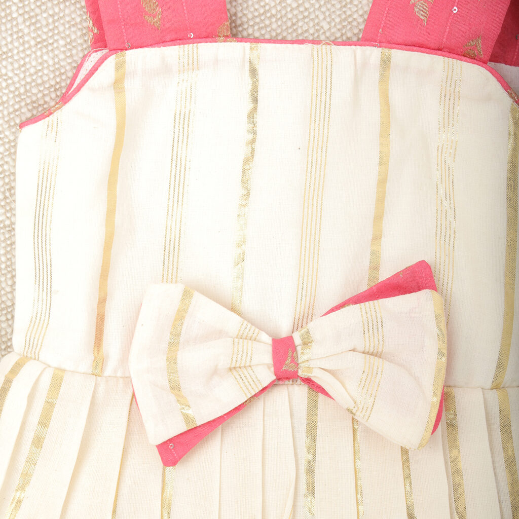 Close up pattern detail on cream and pink traditional kids frock
