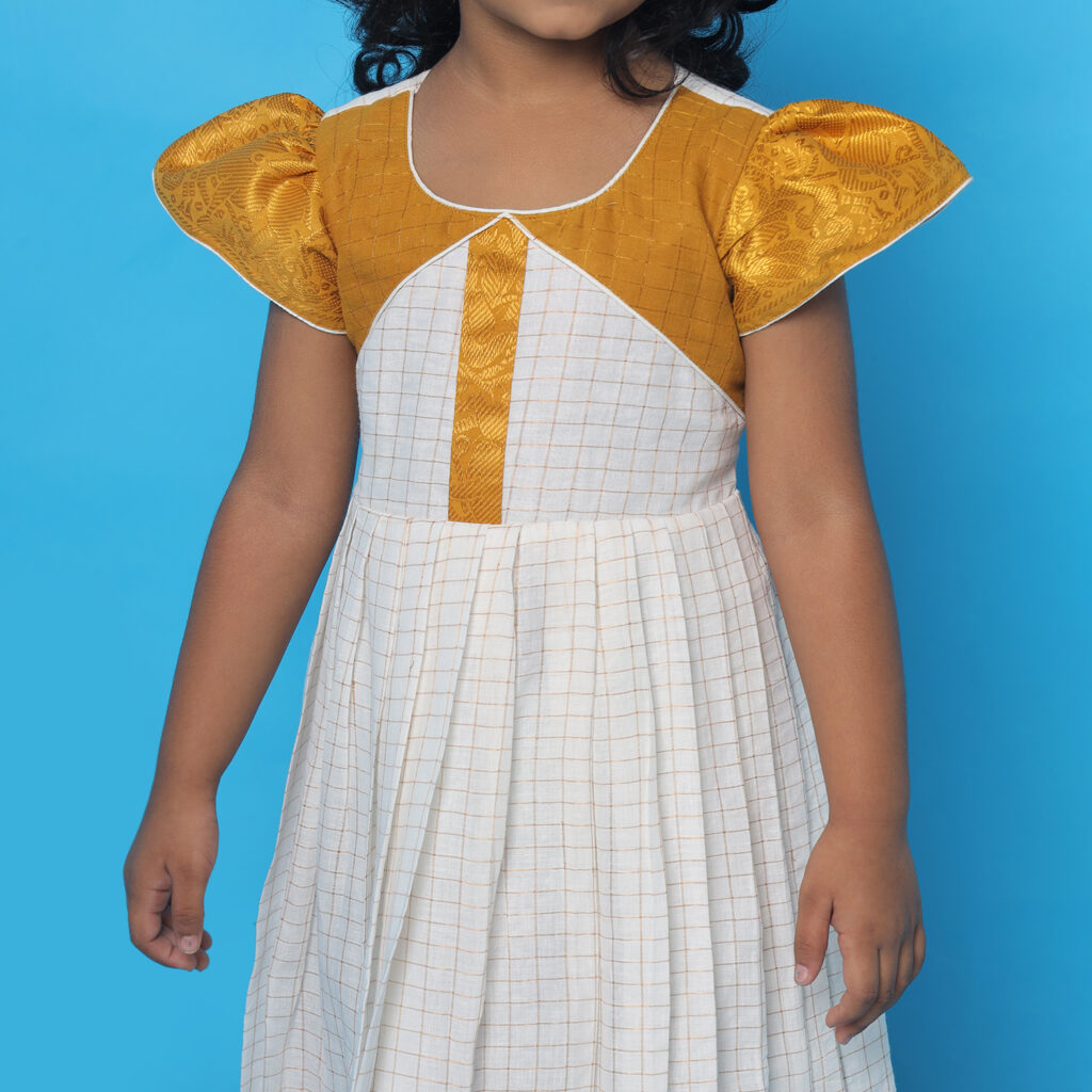 Pattern design detail on Amora mustard white kids frock bodice