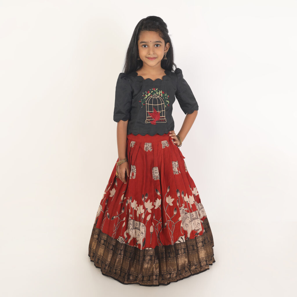 Girls Kalamkari lehenga dress with red printed skirt and black silk crop top front view