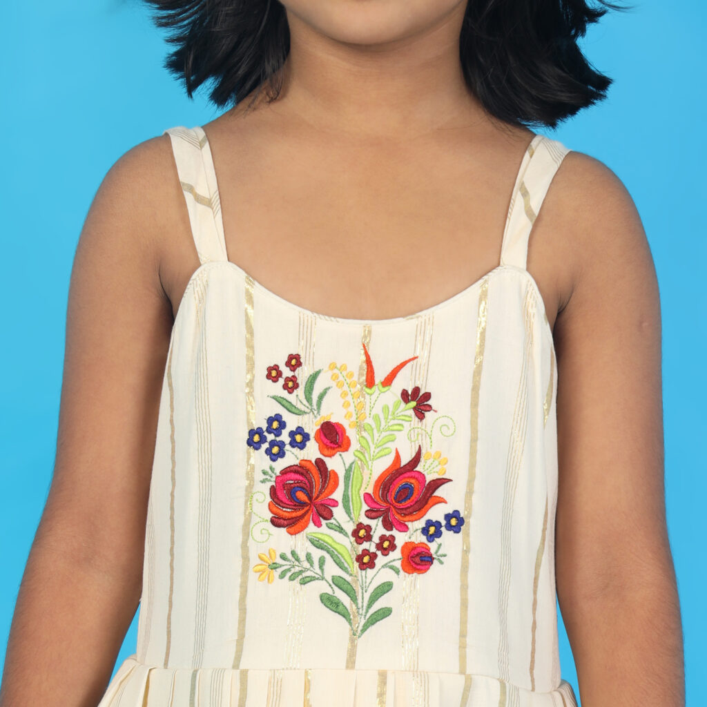 Closeup bloom embroidery detail ivory kids frock luxury designer finish