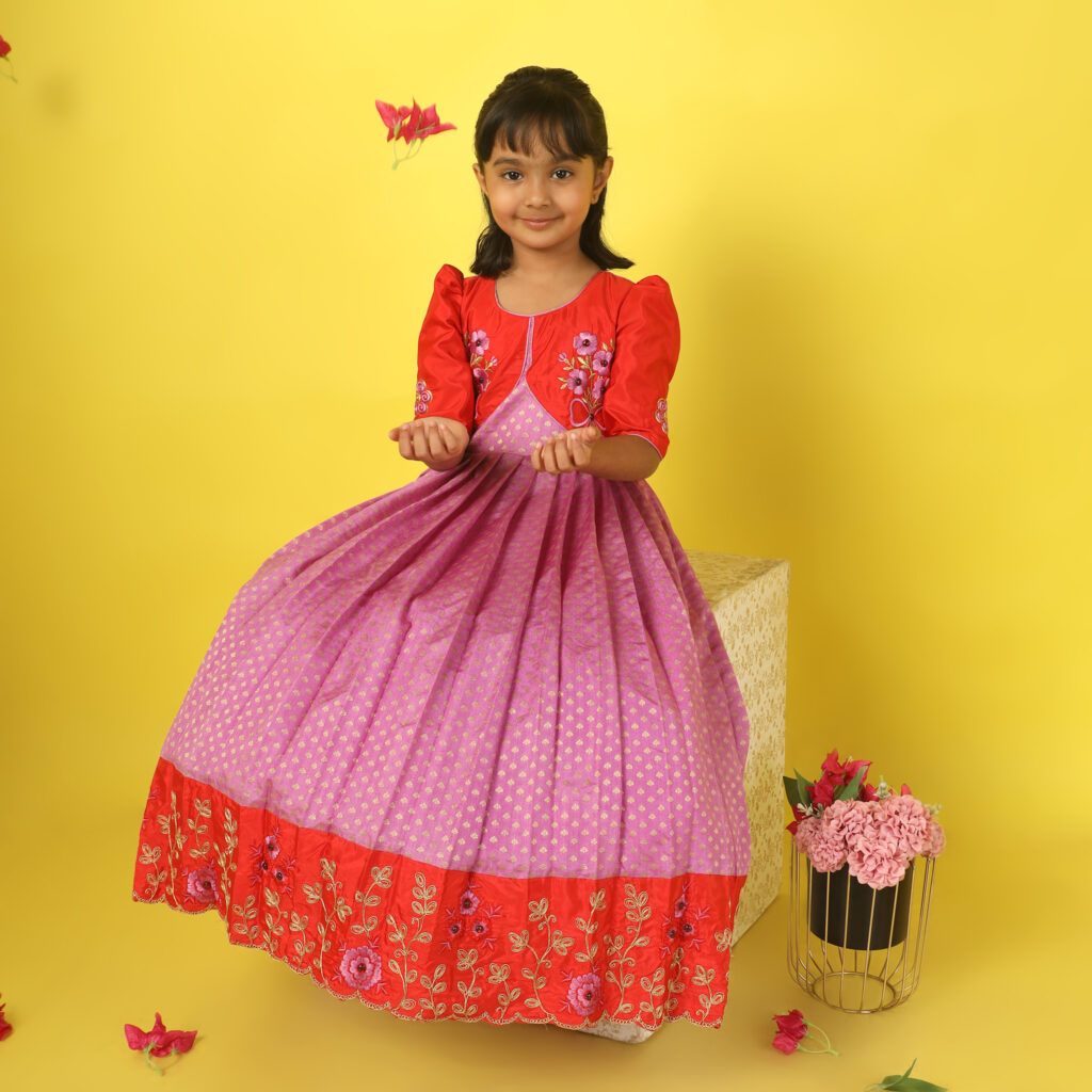 Flower embroidery detail on red silk bodice and sleeve