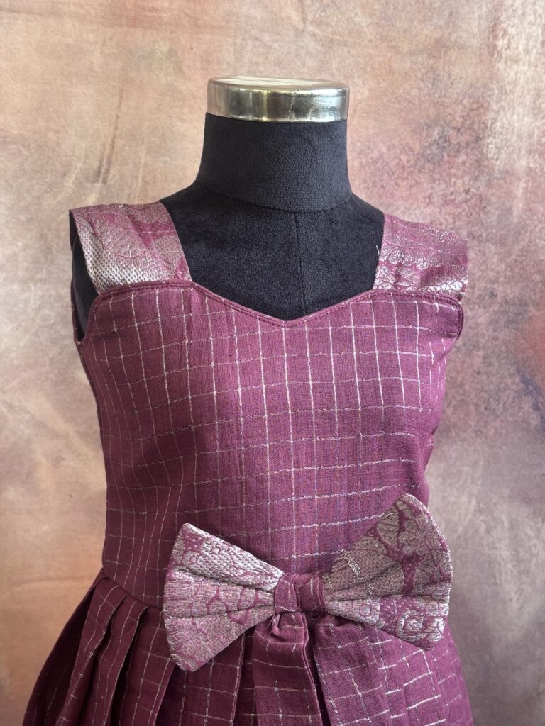 Textile and pattern detail of purple traditional kids frock