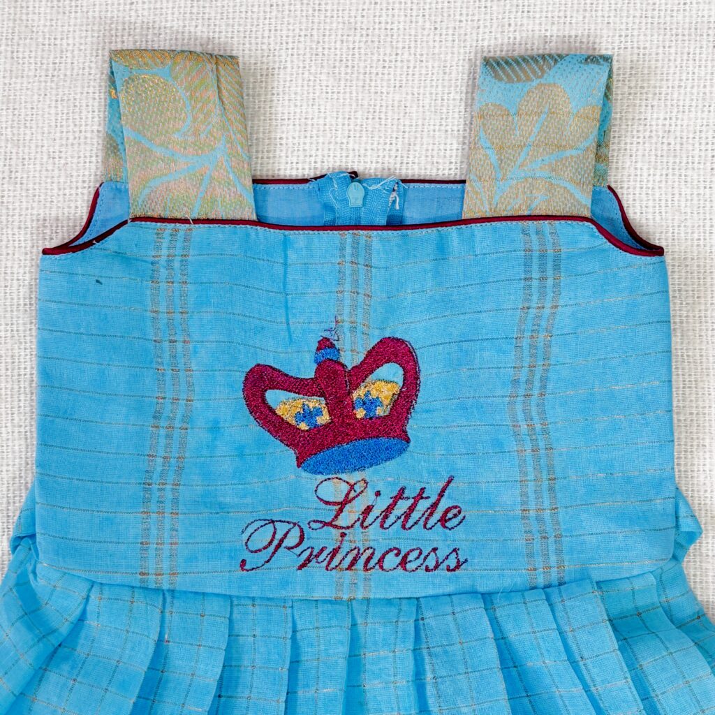 Pleated skirt detail of sky blue Sungudi kids frock