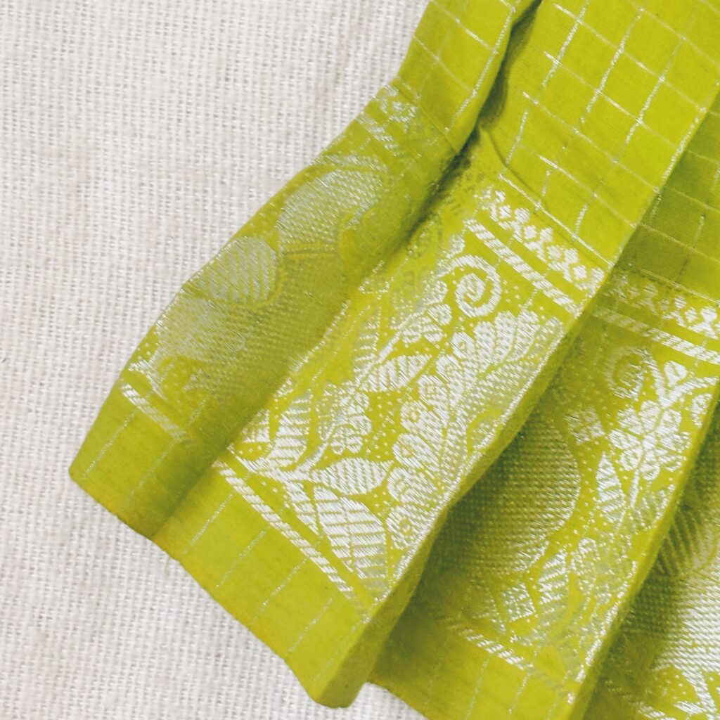 Pleated skirt detail of sky blue Sungudi kids frock