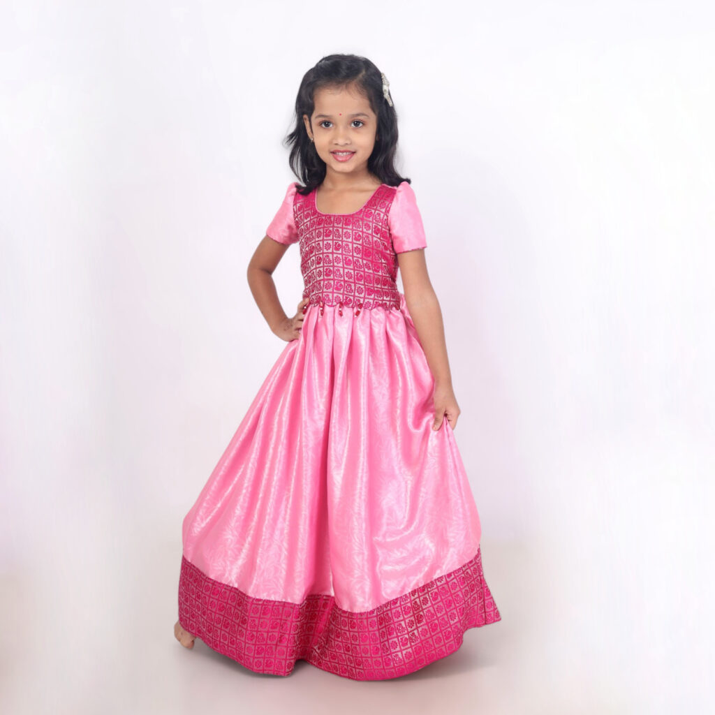 Girls pink long gown in shiny crepe satin front view from Yazh Nila collection
