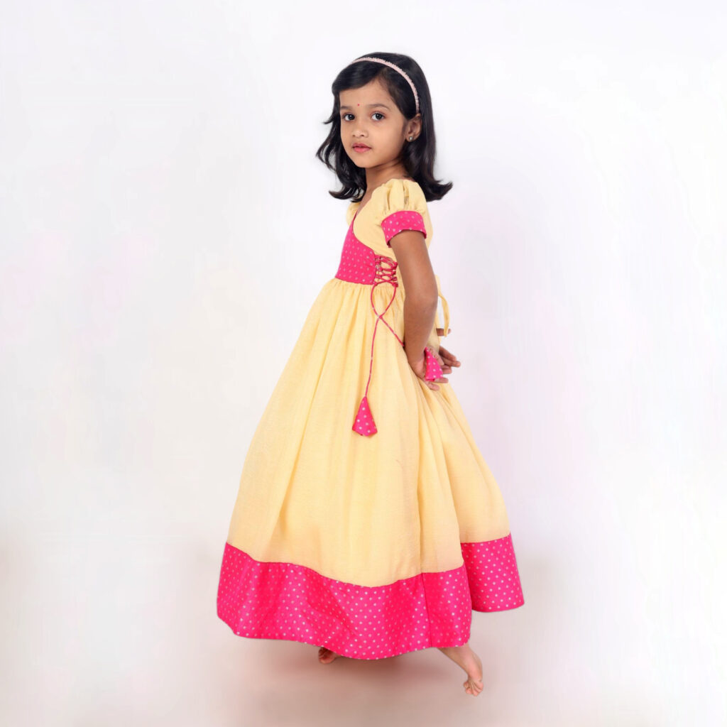 Side view girls pink polka long frock festive wear