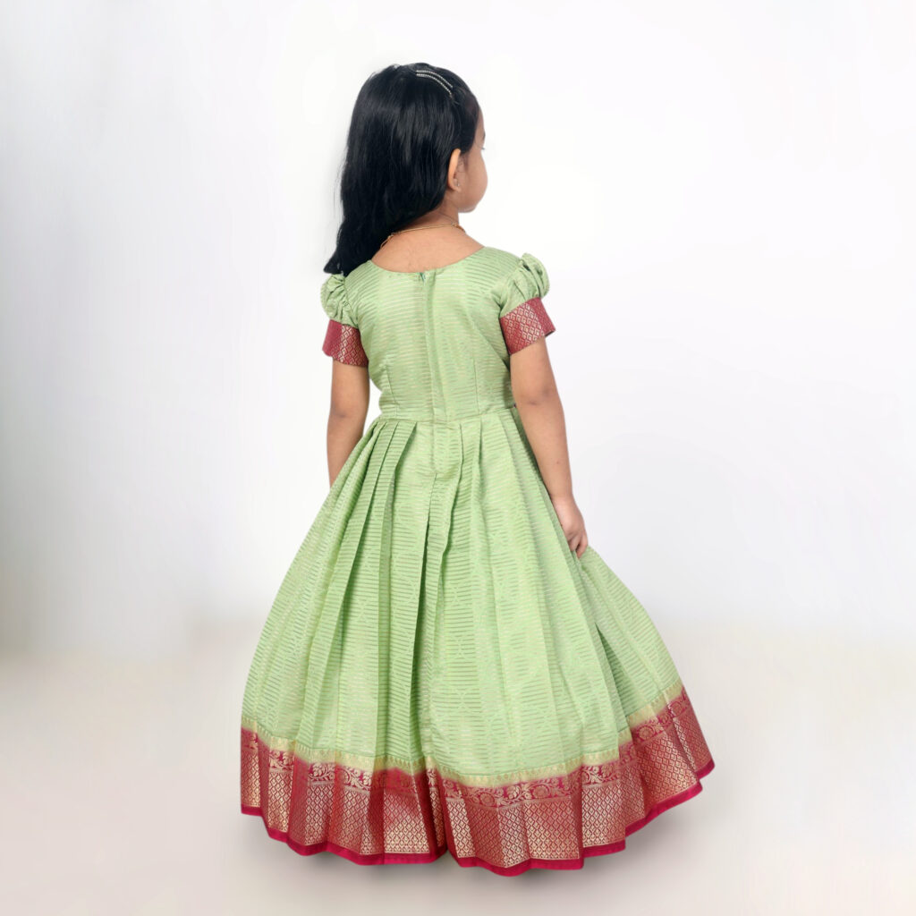 Side view of green crepe silk festive long gown with embroidered belt
