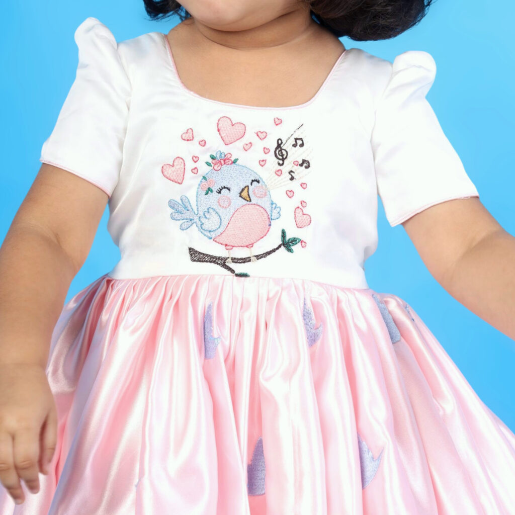 Close up bird motif and scallop embroidery on Aura kids frock