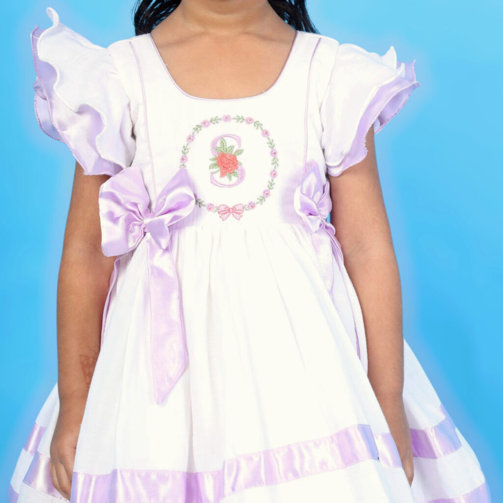 Close up alphabet embroidery and scallop floral detail on Mira kids frock
