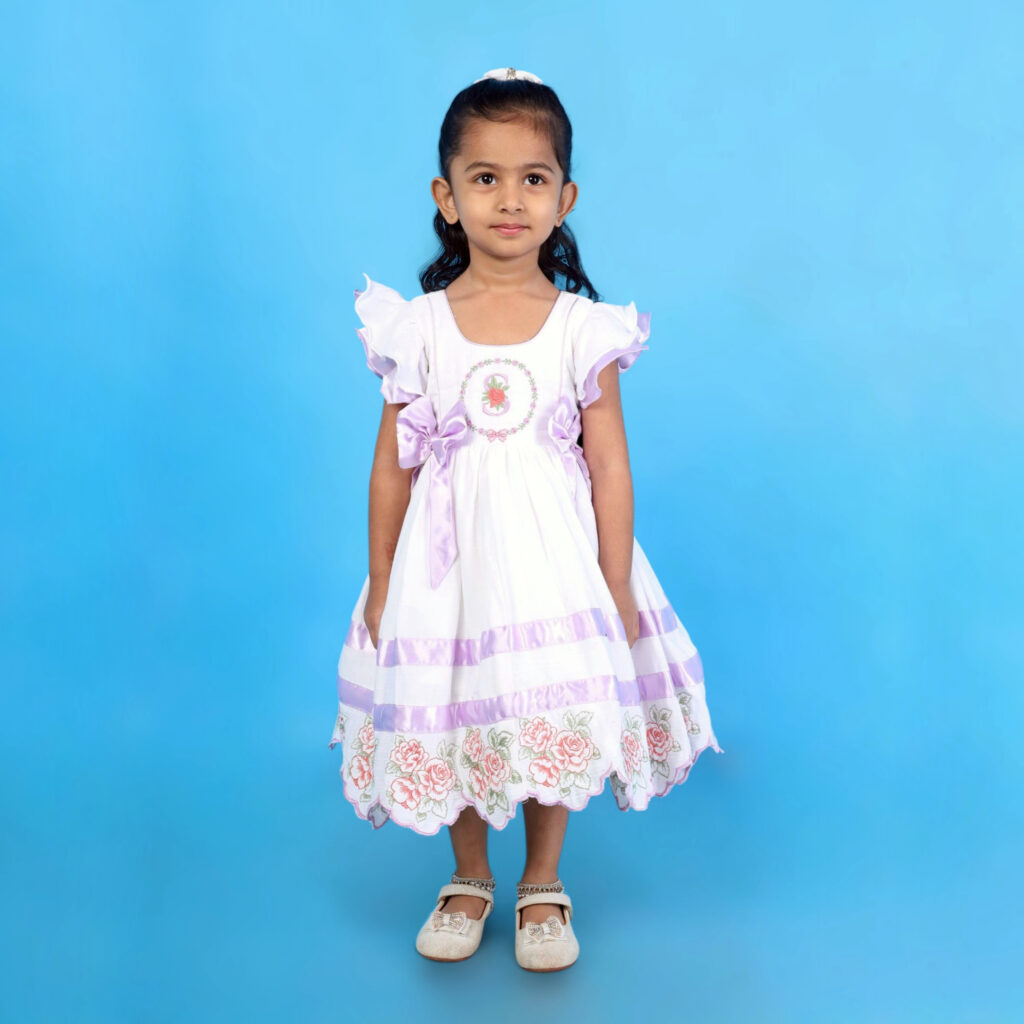 Front view of Mira organic cotton kids frock with custom letter embroidery