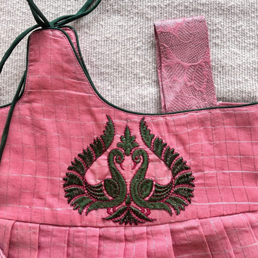 Top view of peacock embroidered kids frock bodice detail