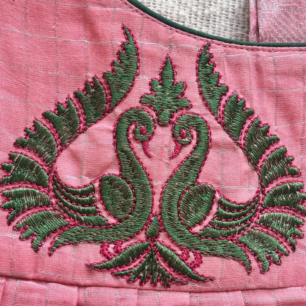 Close up of peacock embroidery on kids frock Sungudi fabric