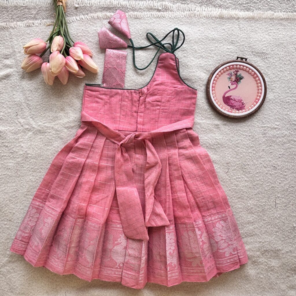 Back view of peacock embroidered kids frock with one shoulder design 1