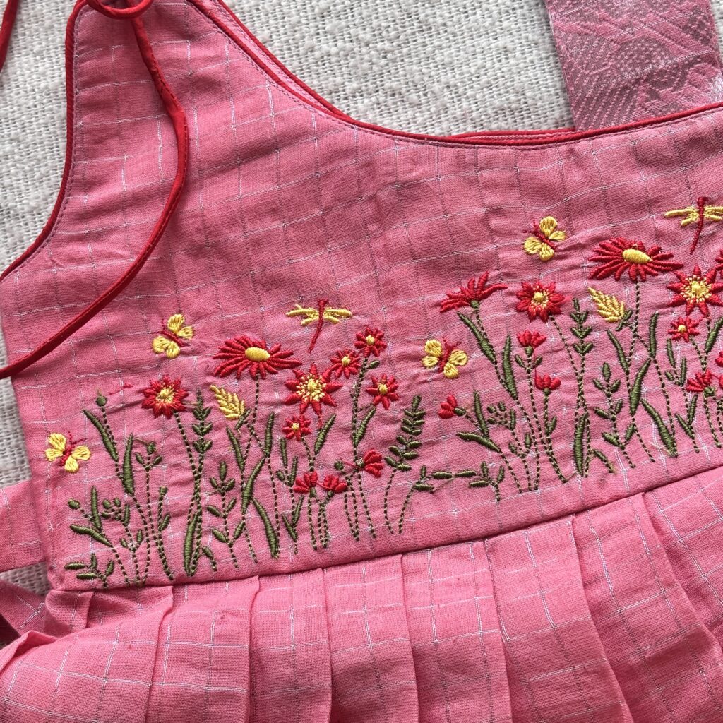 Close up of floral embroidery on kids frock Sungudi fabric