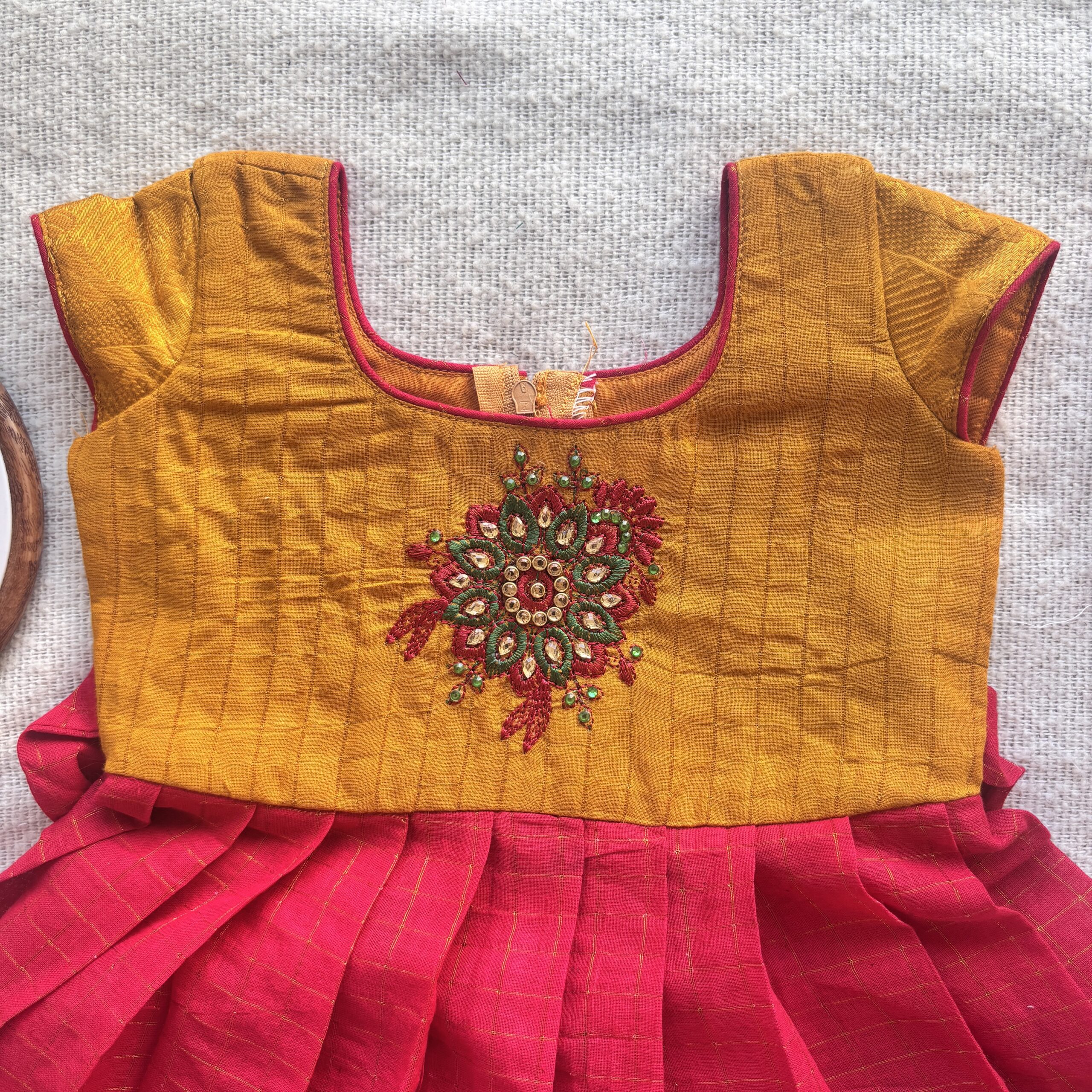 Pleated red skirt detail of mustard yellow and red kids festive frock