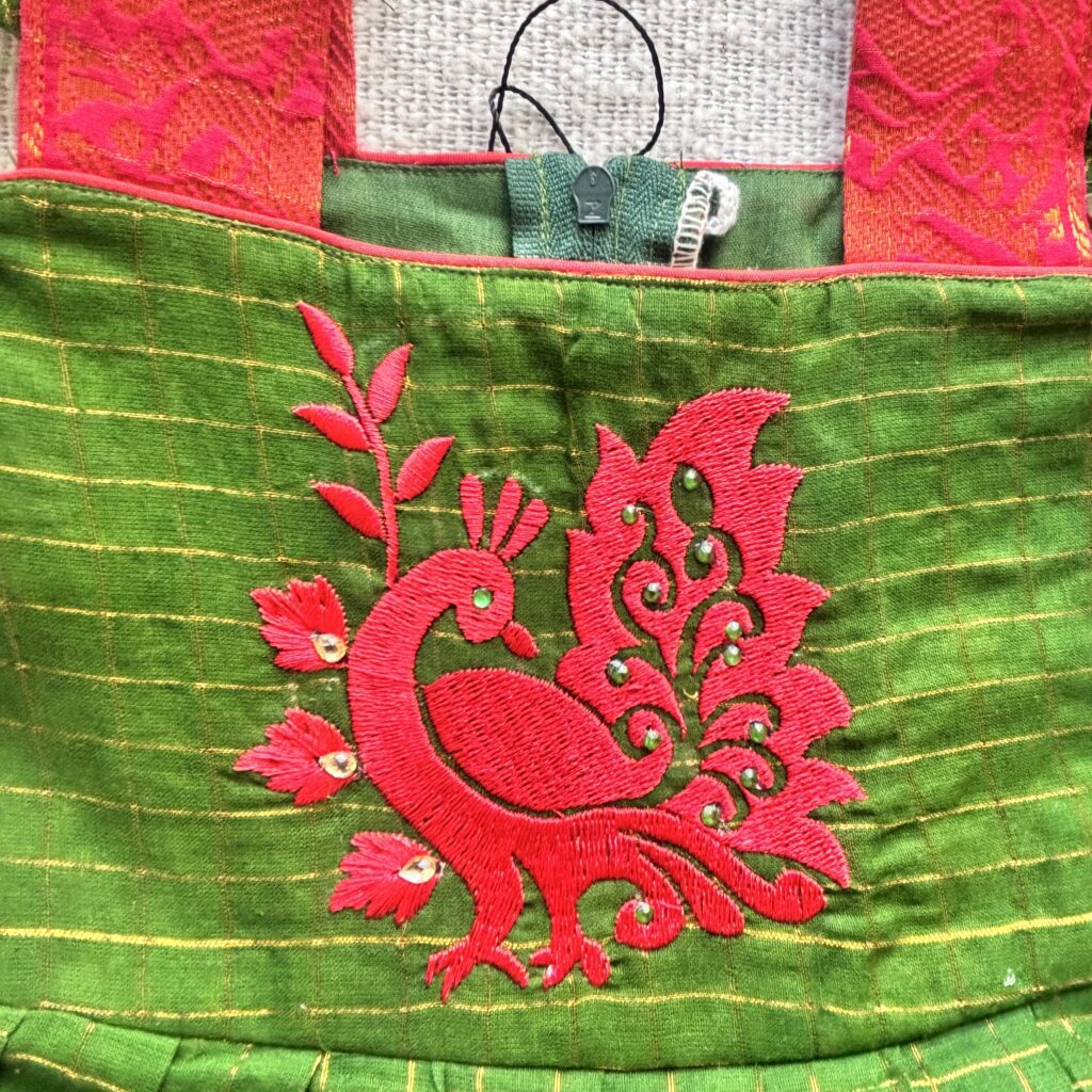 Close-up peacock embroidery on Sungudi kids frock