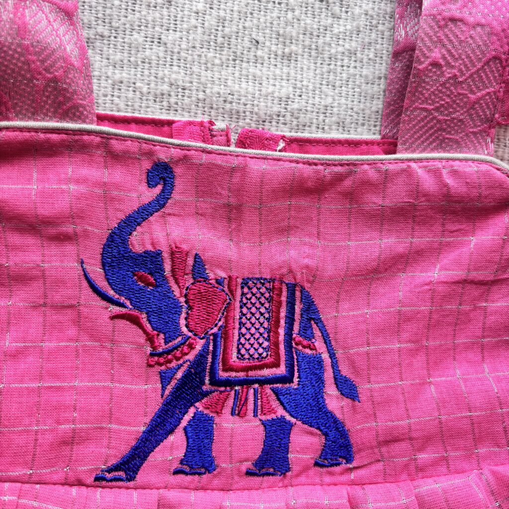 Elephant embroidery detail on pink kids festive frock