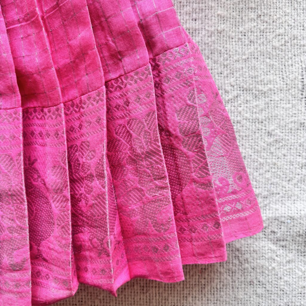 Traditional zari border detail of pink kids festive frock