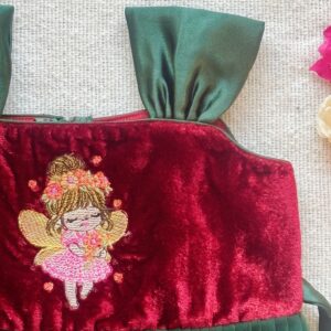 Close up detail of maroon velvet long frock for girls
