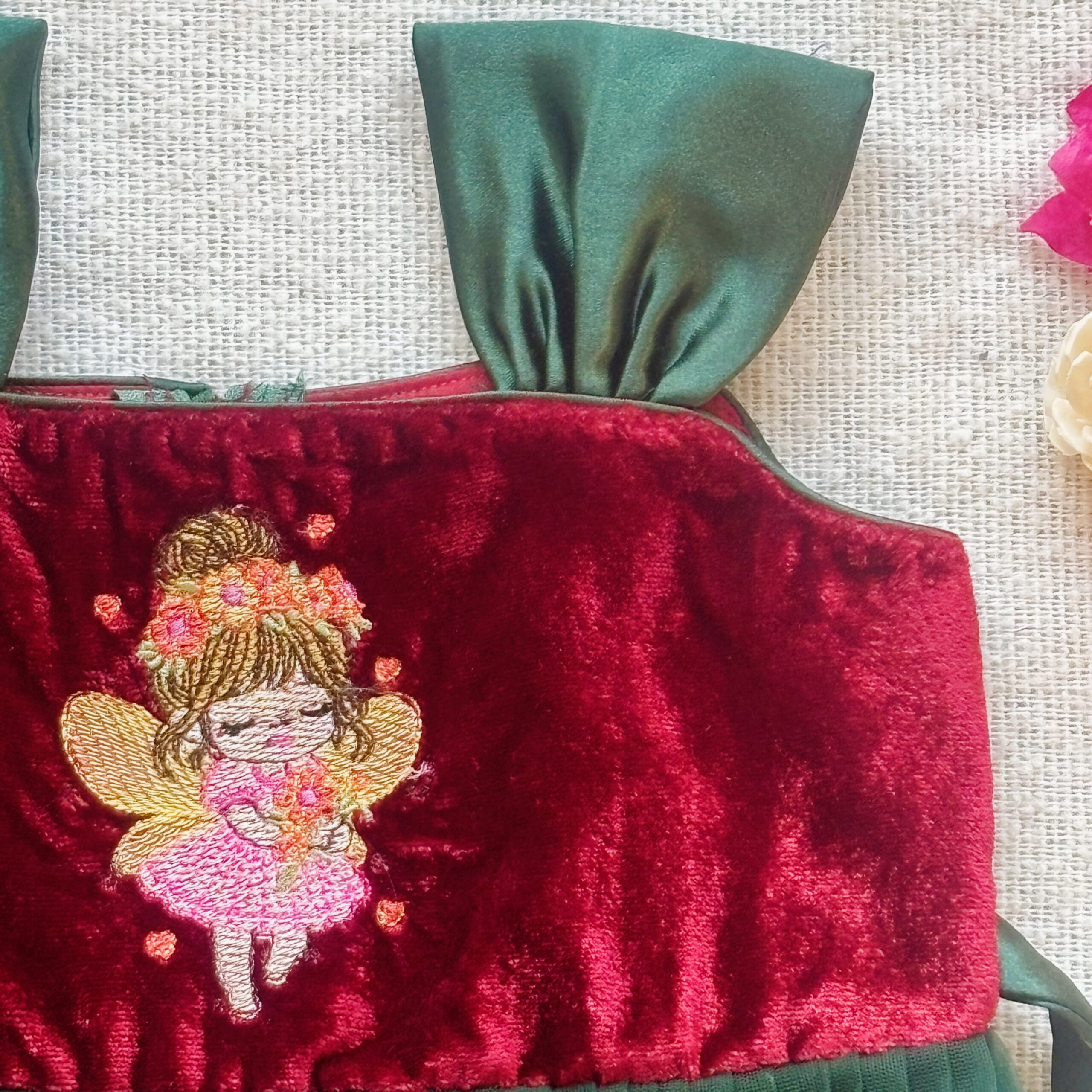 Close up detail of maroon velvet long frock for girls