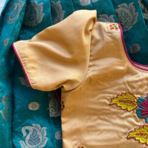 Side view of Taara teal skirt and beige embroidered crop top set for girls sleeves