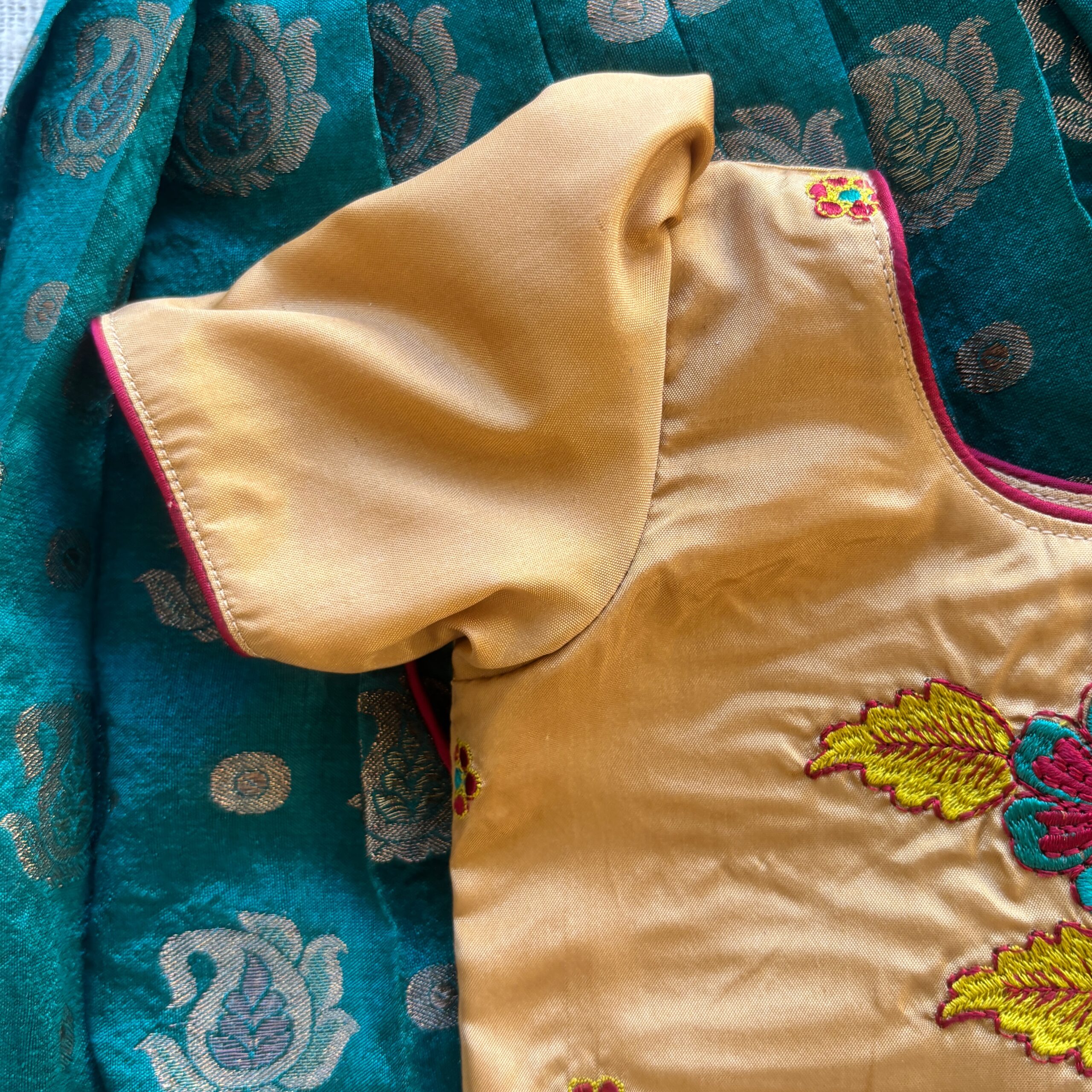 Side view of Taara teal skirt and beige embroidered crop top set for girls sleeves