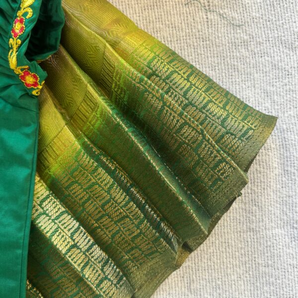 Side view of Taara green kolam skirt and crop top set for girls