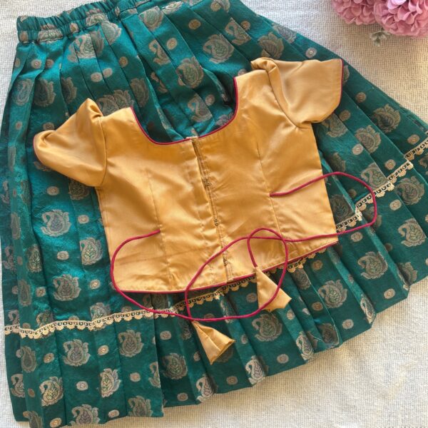 Back view of Taara teal skirt and beige embroidered crop top set for girls
