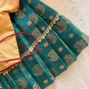 Side view of Taara teal skirt and beige embroidered crop top set for girls