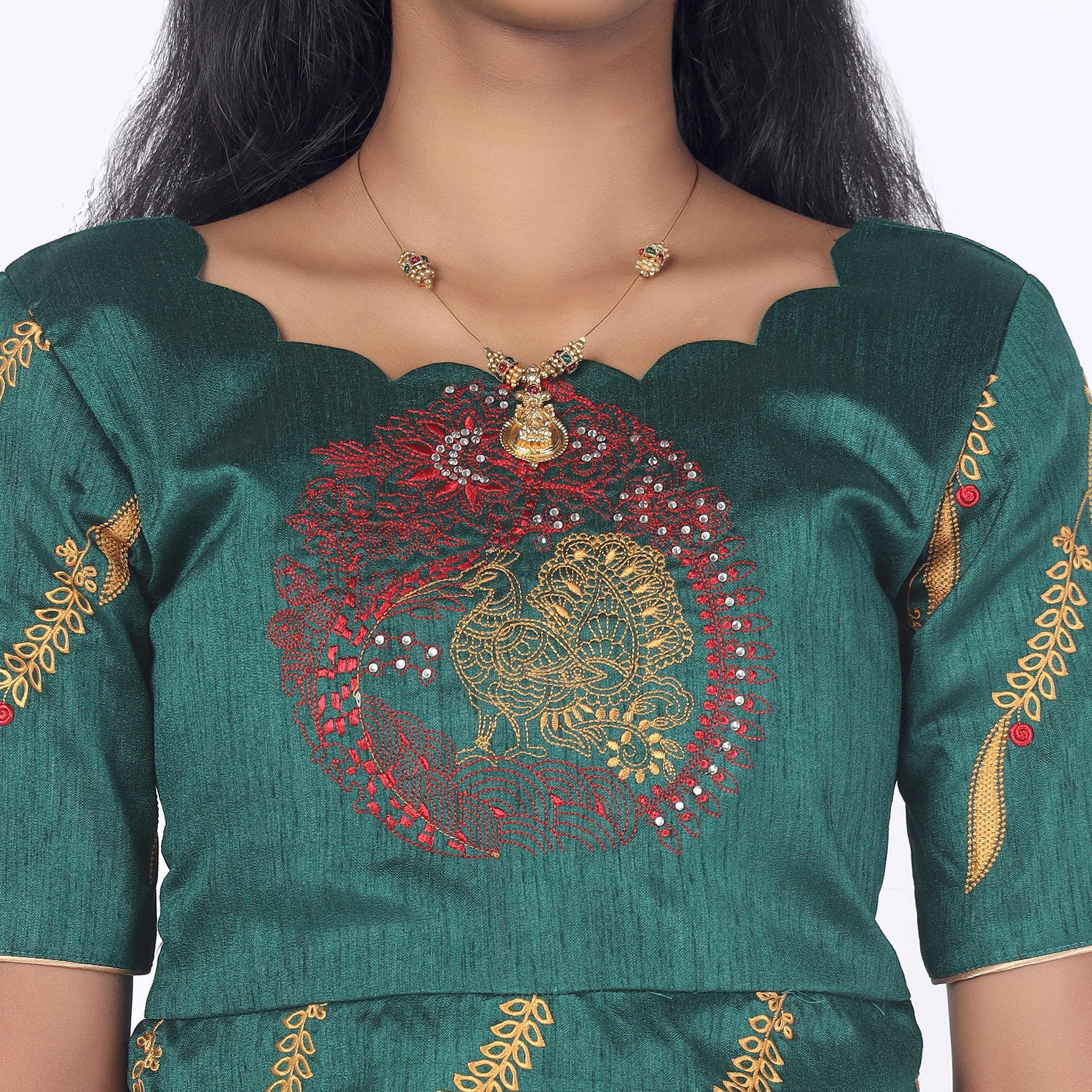 Close up peacock embroidery on bottle green raw silk peplum top