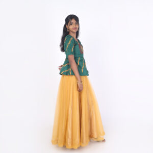 Side profile of mustard net skirt and green embroidered peplum top