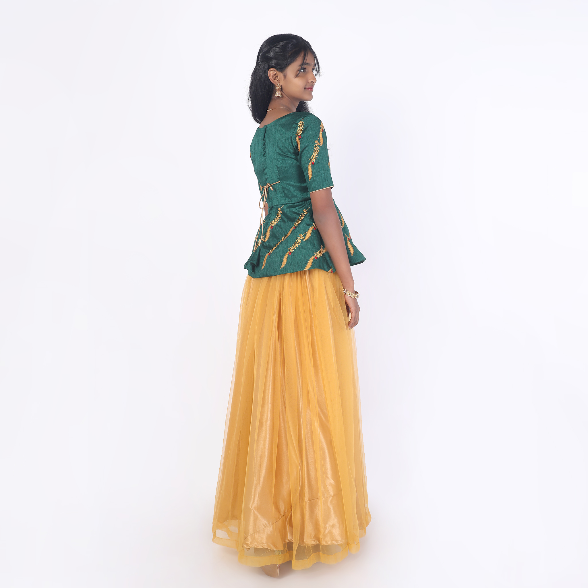 Back view of mustard girls skirt and peplum top set