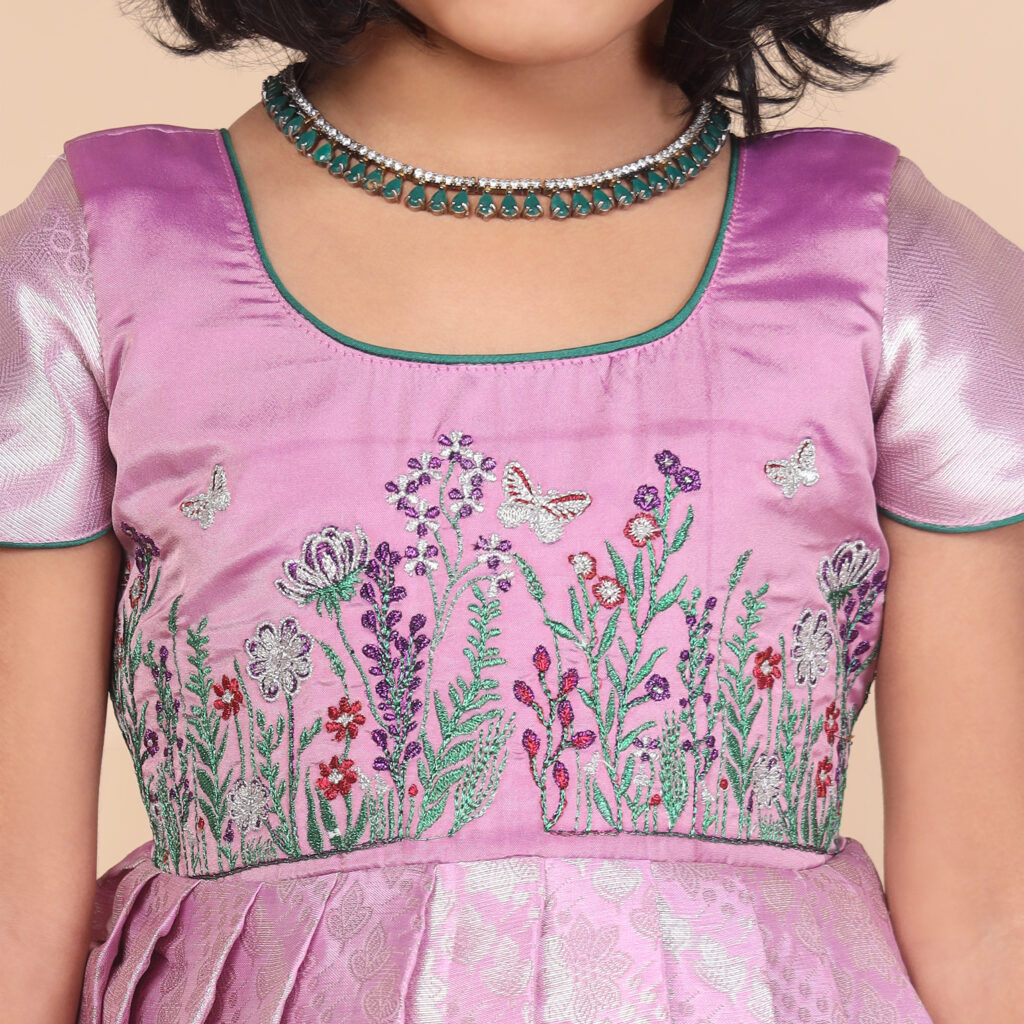 Close up floral garden embroidery on purple kids gown bodice