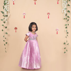 Side profile of purple kids gown with cap sleeves and pleated skirt