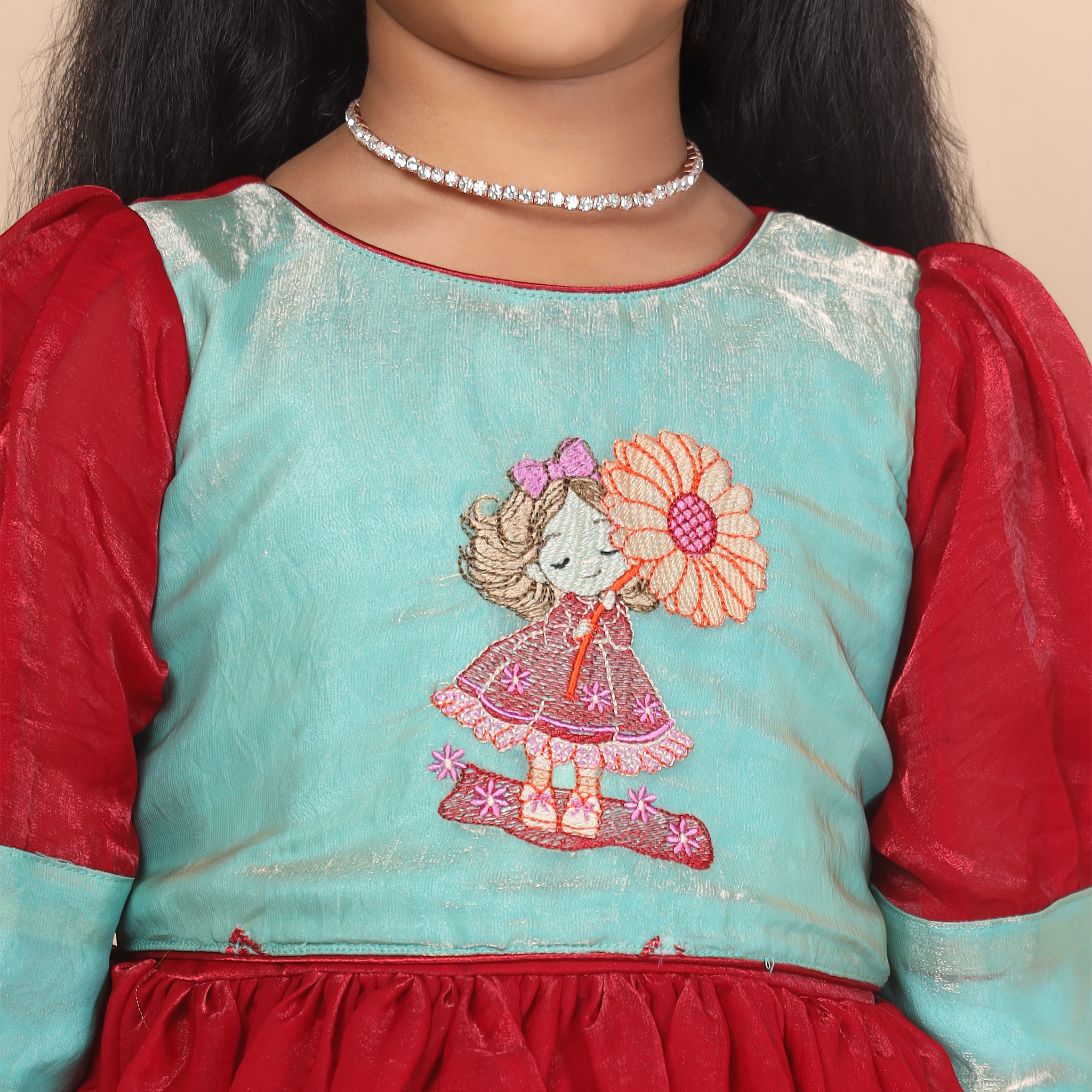 Close up embroidery detail on Yazh Nila girls long gown