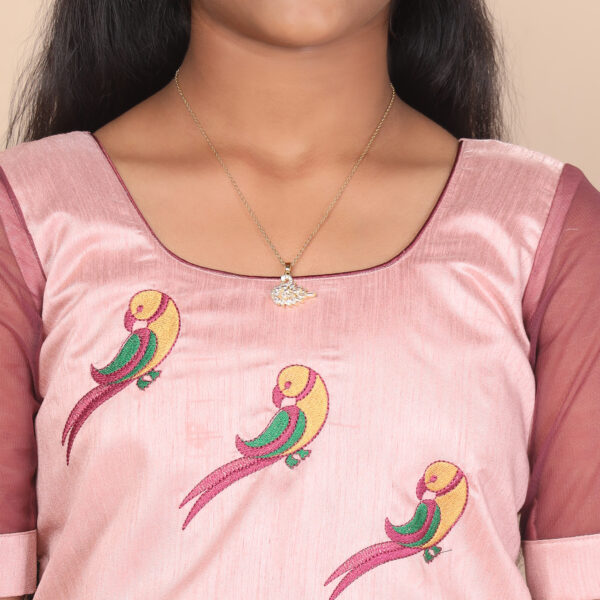 Close up parrot embroidery and scallop cording detail on crop top