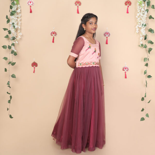 Side profile of mauve netted skirt and raw silk crop top for girls