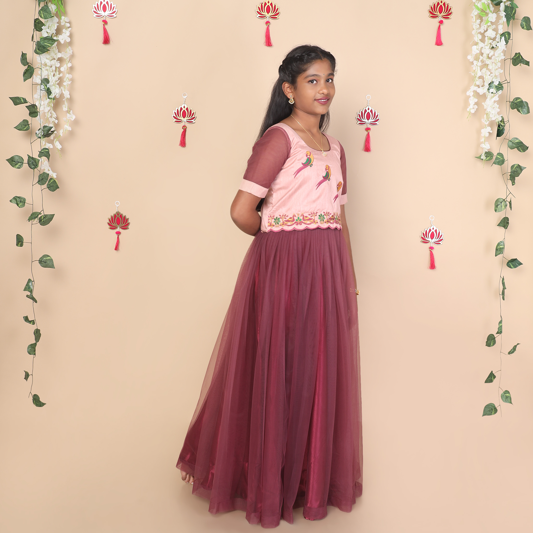 Side profile of mauve netted skirt and raw silk crop top for girls