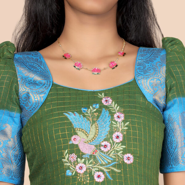 Close up traditional pattern on olive green and blue ethnic long gown