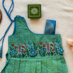 Floral embroidery on green kids frock