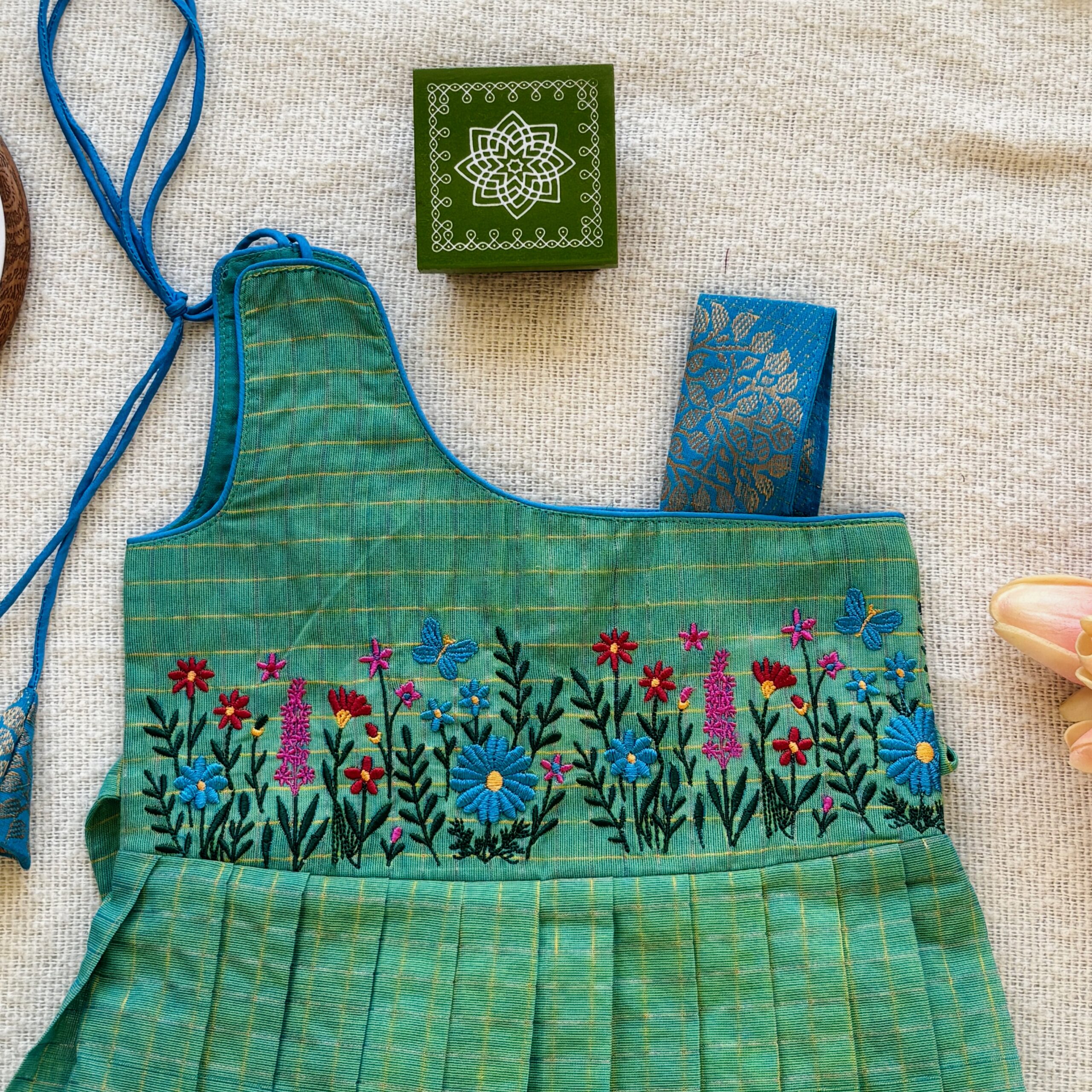Floral embroidery on green kids frock