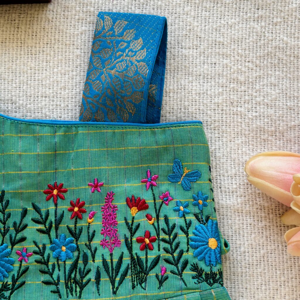 One shoulder design detail of kids festive frock