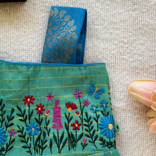 One shoulder design detail of kids festive frock