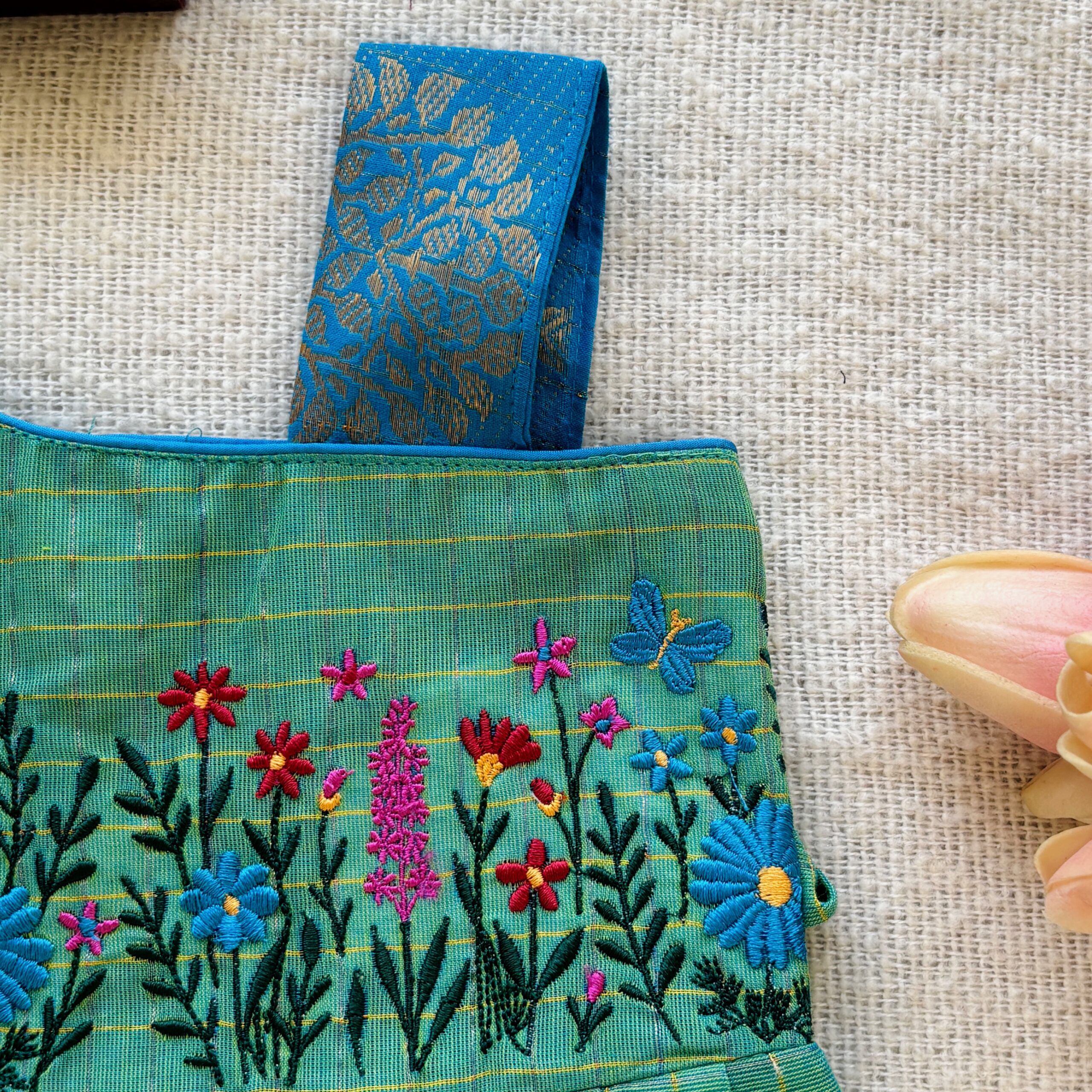 One shoulder design detail of kids festive frock