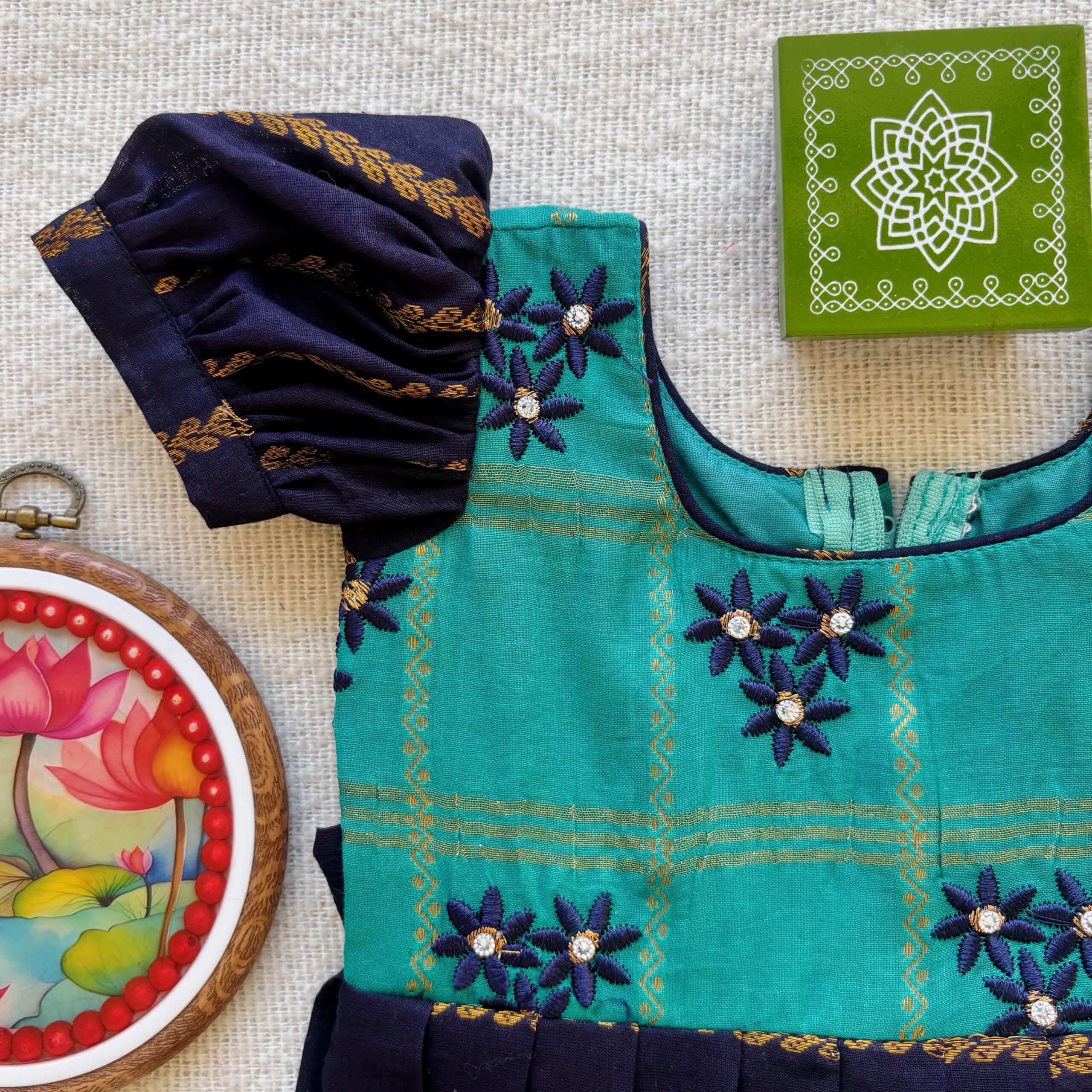 Embroidered teal bodice of kids frock