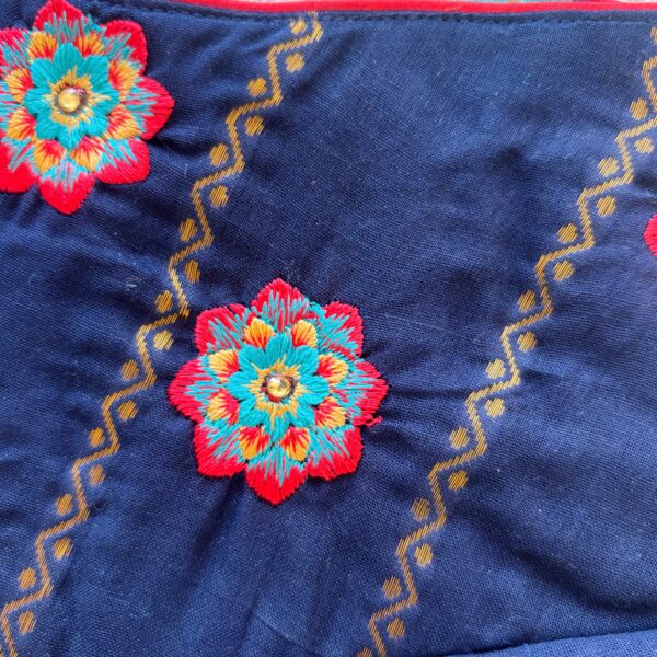 Colorful floral embroidered detail on navy blue kids festive frock