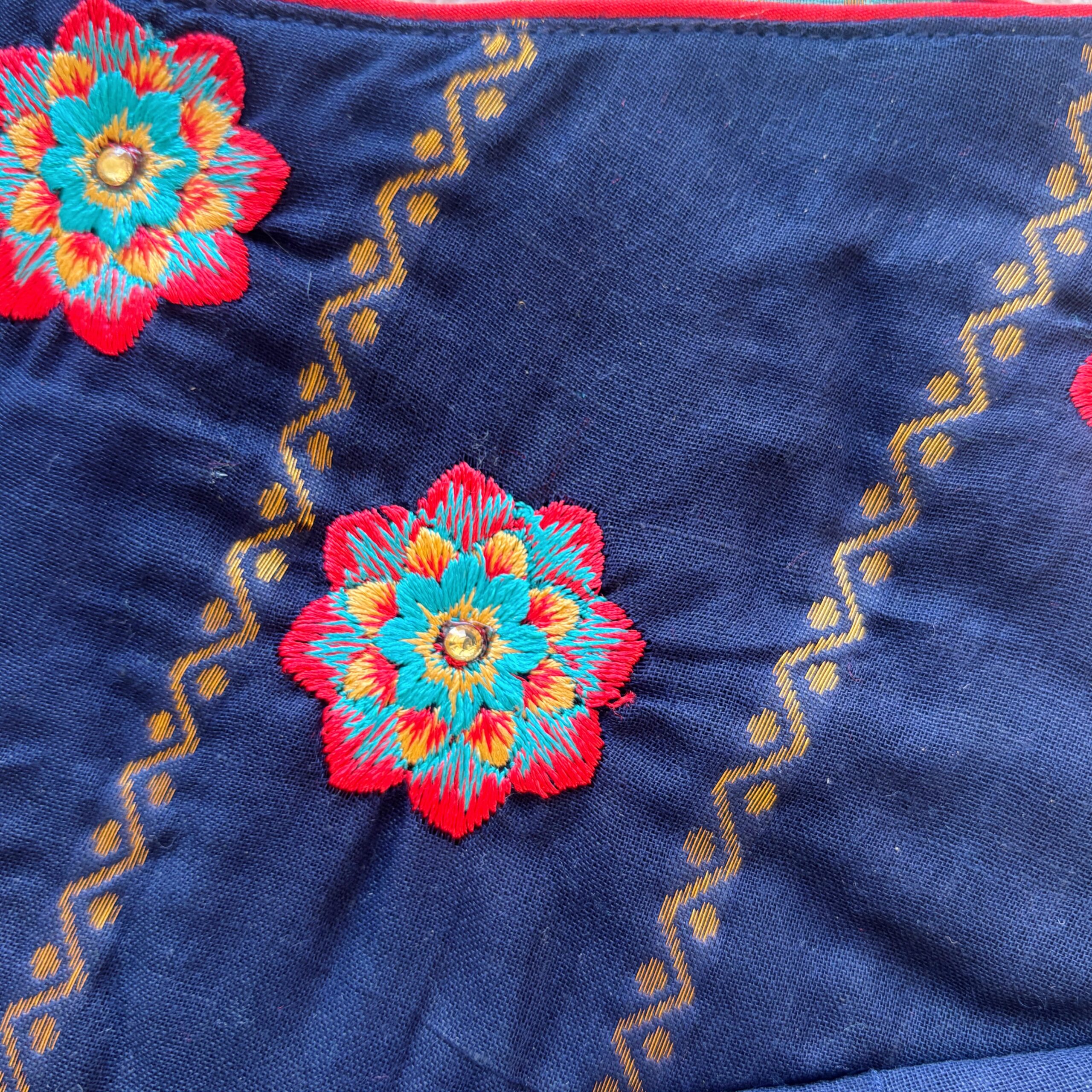 Colorful floral embroidered detail on navy blue kids festive frock