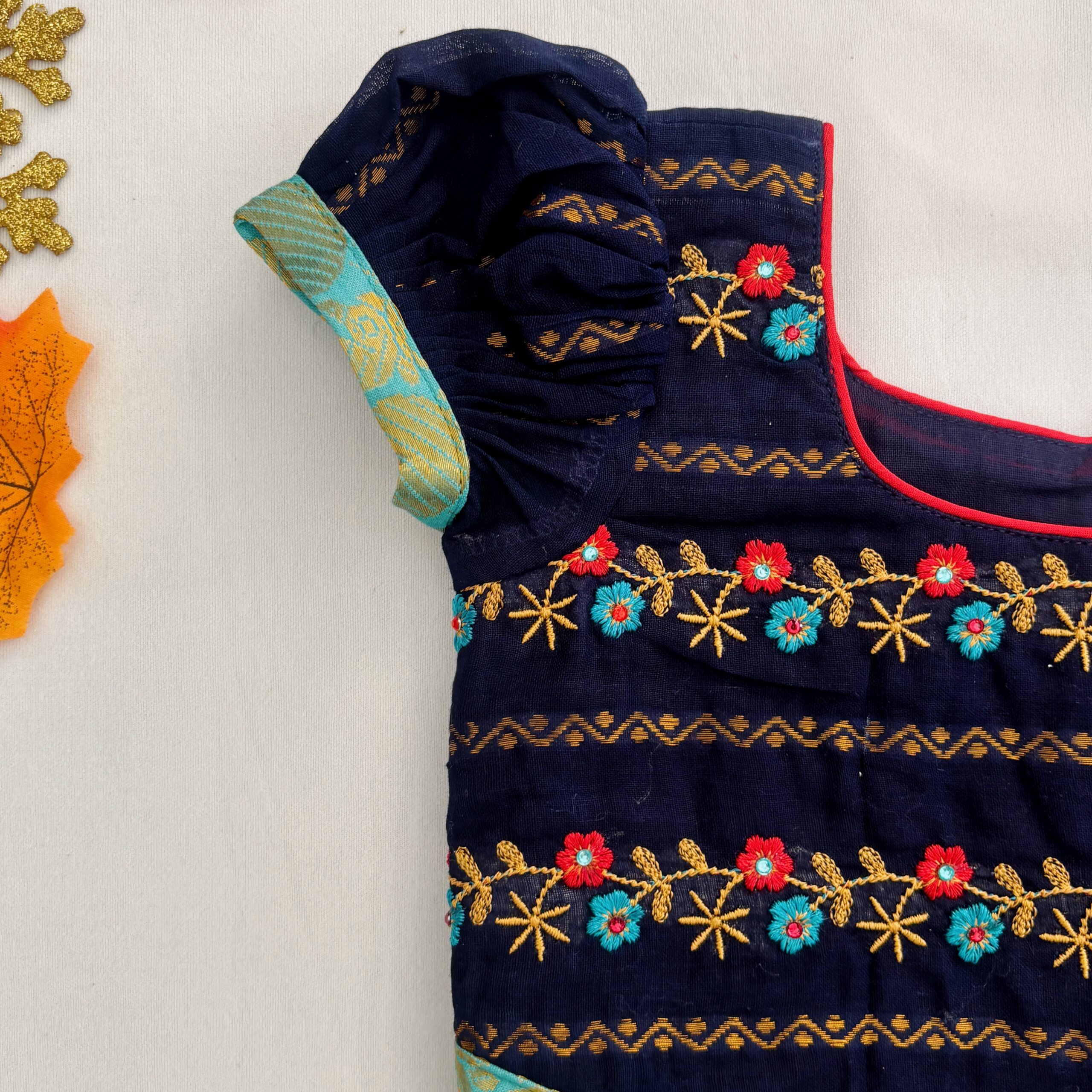Sleeve detail of navy blue embroidered traditional kids frock
